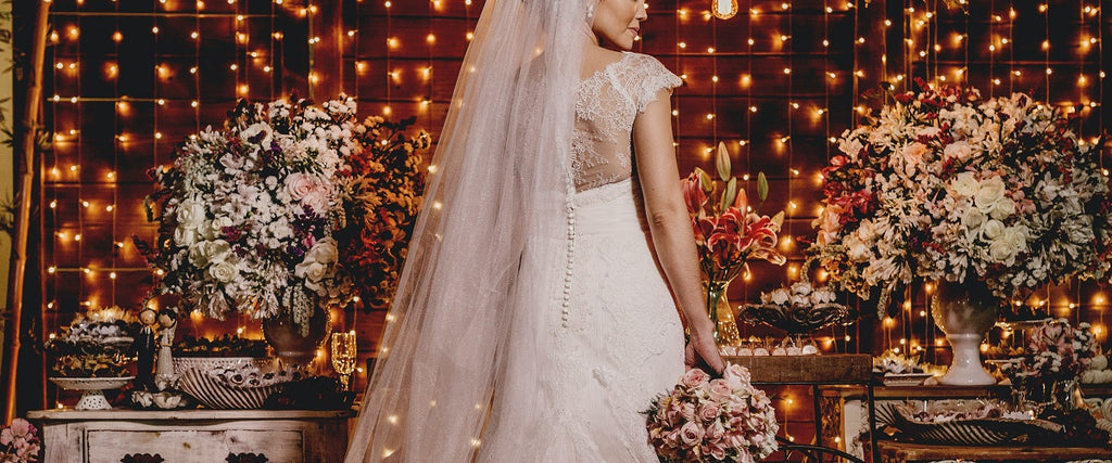 A women in a wedding dress standing with the back towards the camera