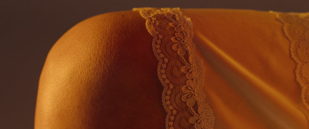 A leg showing of the lace edge of a skirt